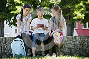 Children playing video games outdoors