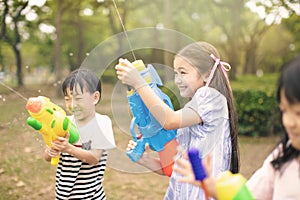 children playing with water guns on summer