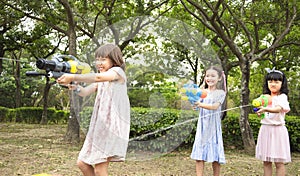 children playing with water guns on summer