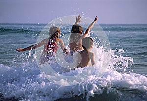 Children playing in the waves