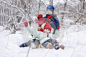 Children are playing in winter snowy forest