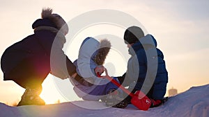 Children playing in winter at sunset