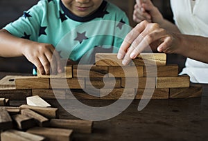 Children Playing Wooden Block Toy with Teacher