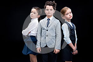 Children posing in business formalwear