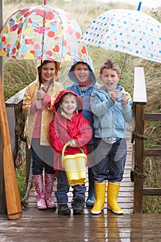 Children posing with umbrella