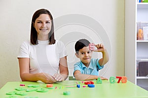 Children practice correct pronunciation with speech therapist