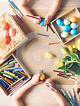 Children prepare for easter. Kids painting eggs. Easter background, flat lay, top view