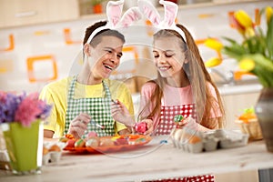 Children preparing colorful Easter eggs