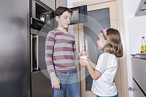 Children preparing a glass of milk