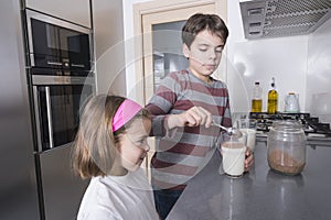 Children preparing a glass of milk