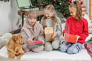 Children preteen opening magic Christmas gift at home. Merry Christmas and Happy Holidays