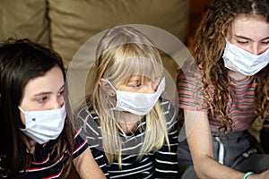 Children protective masks are sitting at home during a pandemic