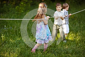 Children pulling the rope outdoors