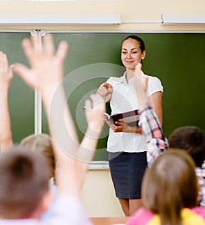 Children raising hands knowing the answer to the question