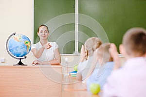 Children raising hands knowing the answer to the question