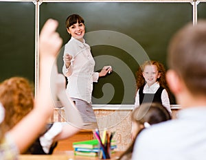 Children raising hands knowing the answer to the question