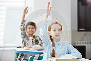 Children Raising Hands in School