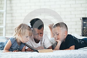 A children read a bible on the bed