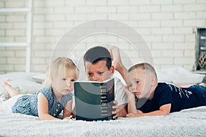 A children read a bible on the bed