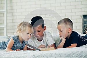 A children read a bible on the bed