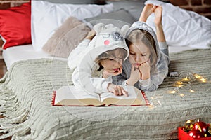 Children read a huge book of Christmas stories.