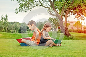 Children reading books in the park
