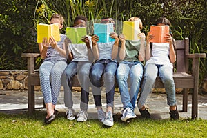 Children reading books at park