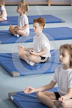 Children in relaxing meditation class