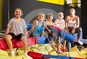 Children rest after intdoor activities in amusement park