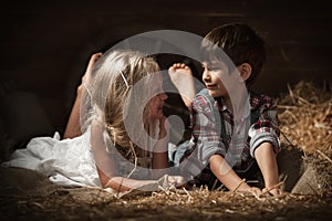 Children rest lying on straw