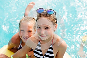 Children rest in the pool in summer