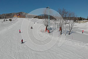 Children ride for adults skier in ski resort