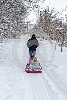 Children ride on sleds