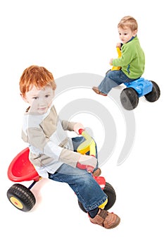 Children riding kids boys tricycles