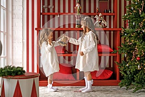 Children ring the bell announcing the imminent arrival of Christmas