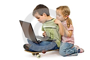 Children rival for using the laptop photo