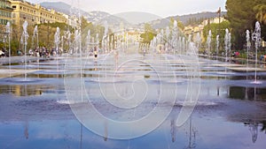 Children romping in fountain at Promenade du Paillon in Nice, summer holidays photo