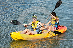 Children Rowing In Kayak
