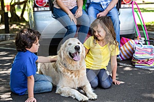 Children ruffling the dogs fur photo