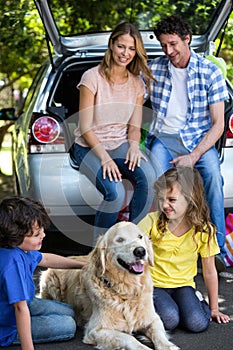 Children ruffling the dogs fur photo