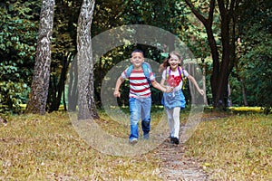 Children run with backpacks. Boy and girl. Back to school. The concept of education, school, childhood