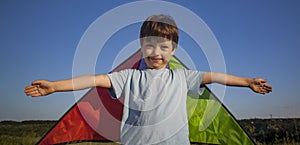 Children run with kite on summer sunset meadow. playing outdoors