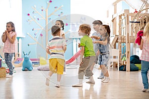 Children run, play educational games in kindergarten or daycare