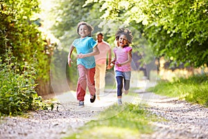 Children Running In Countryside With Father