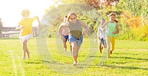 Children running on green grass
