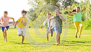 Children running on green grass