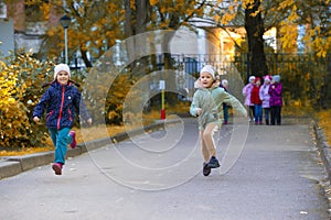 Children running a race on the asphalt path