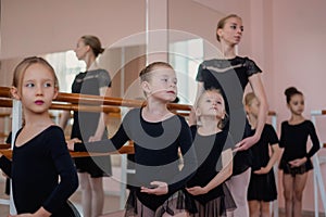 Children& x27;s ballet school. Caucasian woman teaching ballet to little girls.