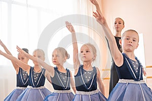 Children& x27;s ballet school. Caucasian woman teaching ballet to little girls.