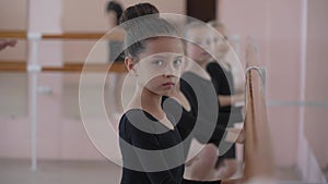 Children's ballet school. Little girls training at the ballet barre.